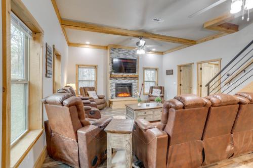 a living room with leather chairs and a fireplace at Greers Ferry Lake Access and Deck Group Getaway! in Heber Springs