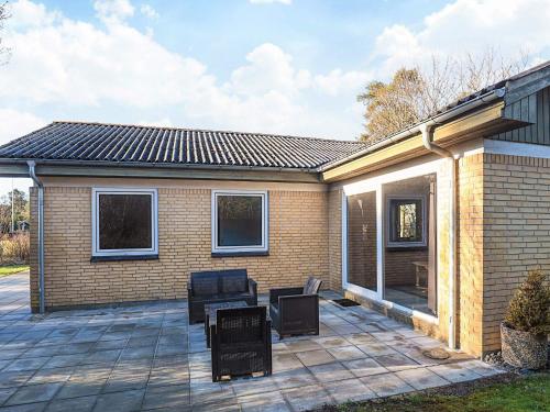 a patio with two chairs and a house at 4 star holiday home in Hals in Hals