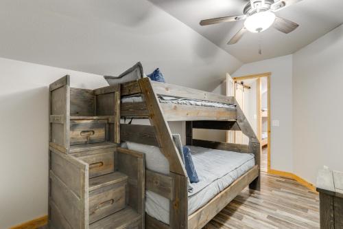 a bunk bed in a room with a ceiling fan at Greers Ferry Lake Access and Deck Group Getaway! in Heber Springs