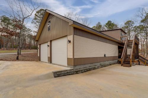 a large building with a staircase in front of it at Greers Ferry Lake Access and Deck Group Getaway! in Heber Springs
