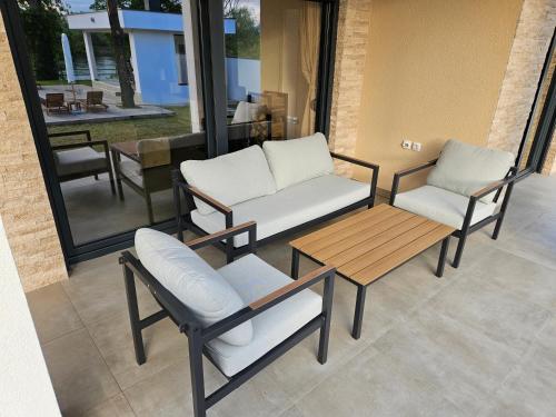 two chairs and a coffee table on a patio at Drina Lux in Loznica