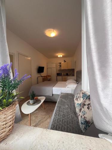 a hotel room with a bed and a couch at Apartments Versus in Mlini