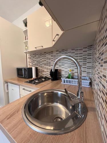 a kitchen with a stainless steel sink in a kitchen at Apartments Versus in Mlini