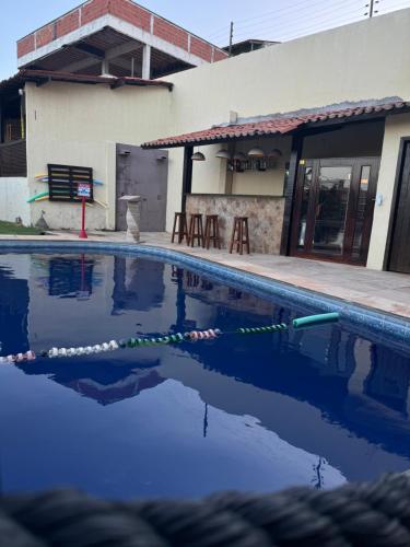 a swimming pool in front of a building at Pousada Vila Italia - Porto da Dunas in Aquiraz