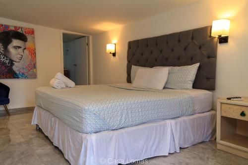 a bedroom with a large bed with a large headboard at Casa Lomas in Tegucigalpa
