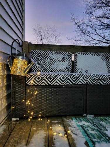 a porch with a bench with lights on it at Cozy House in Long Pond 3 bedrooms 10 people in Long Pond