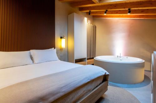 a bedroom with a bed and a bath tub at Locanda Expanificio in Agrigento