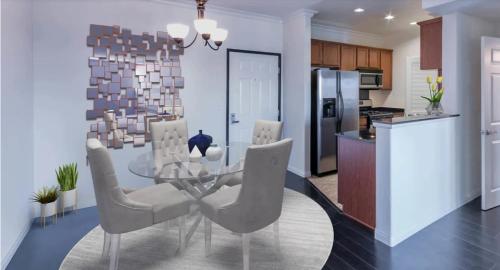 a kitchen and dining room with a glass table and chairs at LALA House -1Br with Free Parking, Pool, Laundry in Los Angeles