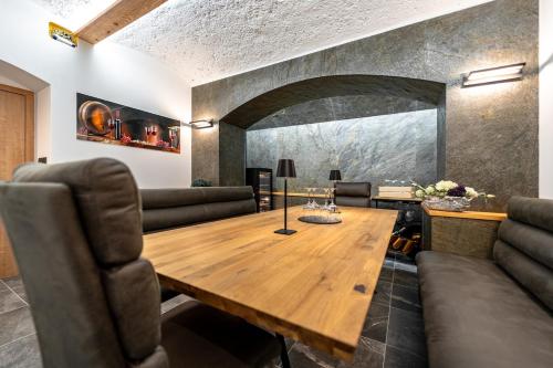 a dining room with a wooden table and chairs at Apartmán Horský Sklípek in Trutnov