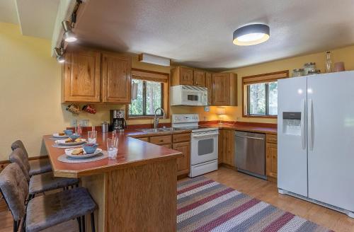 a kitchen with wooden cabinets and a white refrigerator at Alpine Breakwater in Alpine