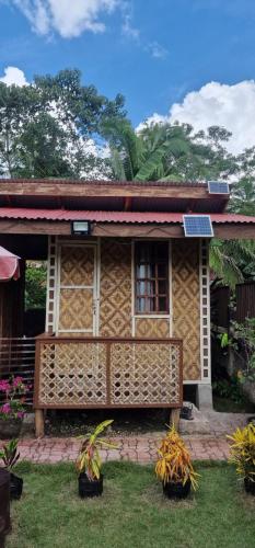 a house with a solar panel on the front of it at Khloe Serenity Guest House in Batuan