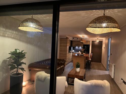 a living room with two chandeliers and a couch at The Roses in Puerto Varas