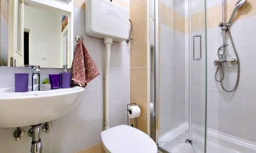 a bathroom with a shower and a toilet and a sink at Mendys Sea View - Pomalo & Fjaka Retreat in Kaštela