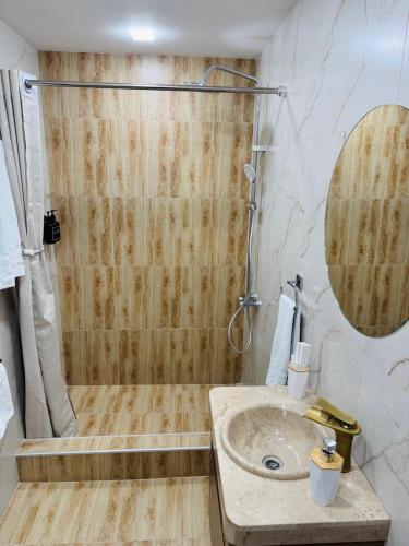 a bathroom with a shower and a sink at Lux Plaza Hotel EVN airport in Arbatʼ