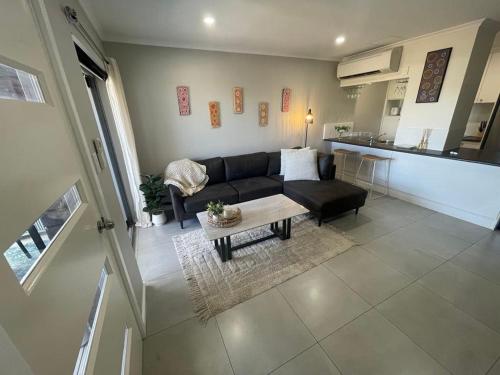 a living room with a couch and a table at Unit in Stuart in Alice Springs