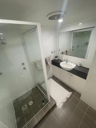 a bathroom with a glass shower and a sink at Unit in Stuart in Alice Springs