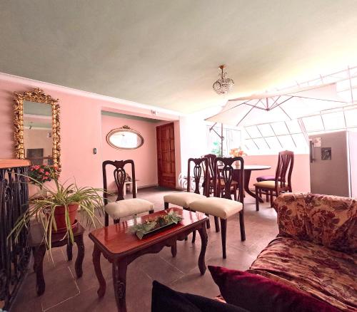 a living room with a couch and a table at Residencial Belle Maison in Cusco