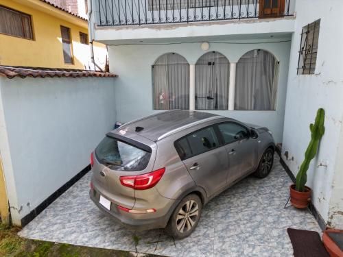 a car parked in a parking lot next to a building at Residencial Belle Maison in Cusco