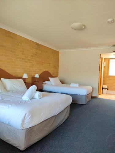 a hotel room with two beds and a window at Kandos Hotel in Kandos