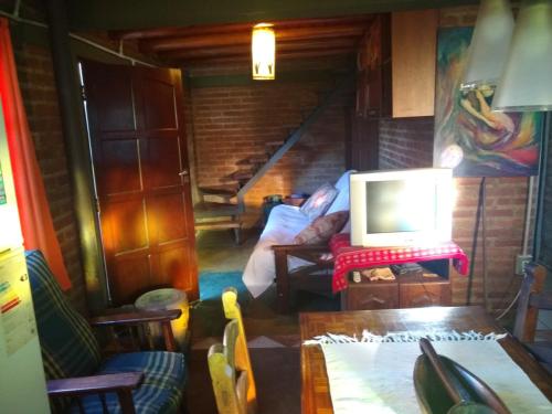 a room with a staircase with a laptop on a table at Casita Loma Hermosa in Mina Clavero