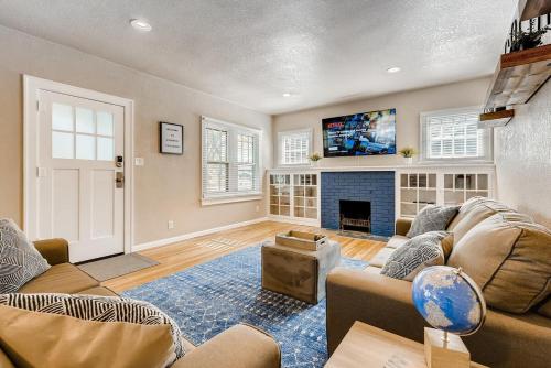 a living room with a couch and a fireplace at Olympic House Downtown w Hot Tub Fire pit & BBQ in Colorado Springs