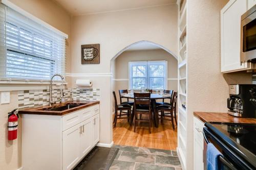 a kitchen with a table and a dining room at Olympic House Downtown w Hot Tub Fire pit & BBQ in Colorado Springs