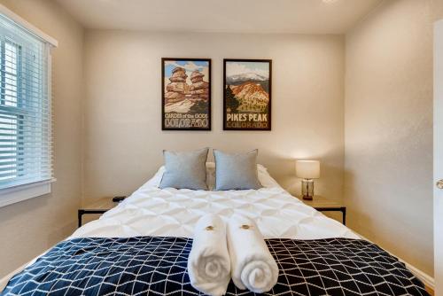 a bedroom with a bed with two towels on it at Olympic House Downtown w Hot Tub Fire pit & BBQ in Colorado Springs