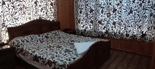 a bedroom with a bed with a laptop on it at Magnolia Homestay in Srinagar