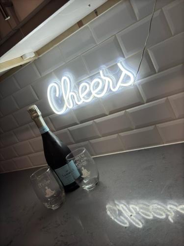 a bottle of wine and two glasses on a counter at Horizon Hideaway in Mobile