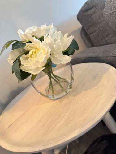 a vase with white flowers sitting on a table at Horizon Hideaway in Mobile
