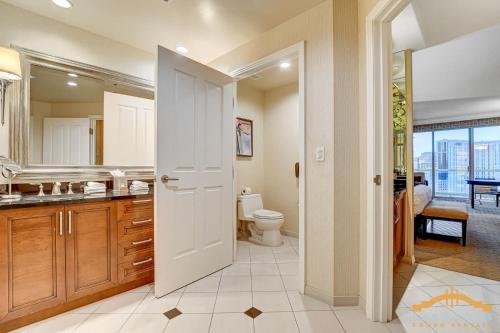 a bathroom with a toilet and a sink and a mirror at MGM Signature-22-615 Strip View Balcony Studio in Las Vegas
