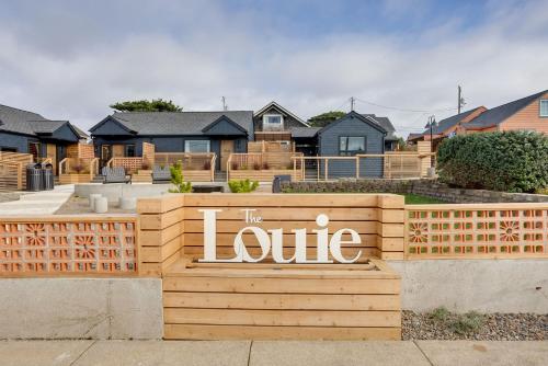 a sign that says the love in front of some houses at The Reed at The Louie Boutique Motel, Private Sauna! Walk to Everything! in Newport