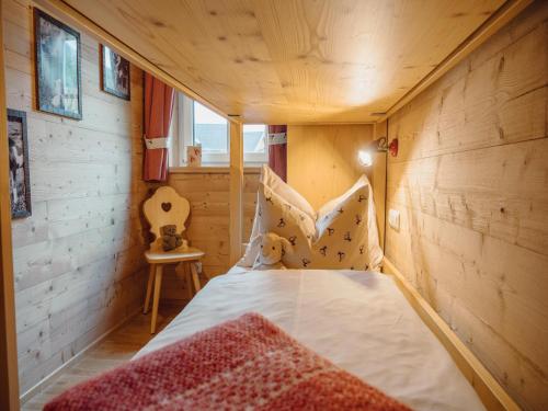 a bedroom with a bed in a wooden room at Chalet near Lake Grundlsee & Ski Lift in Grundlsee