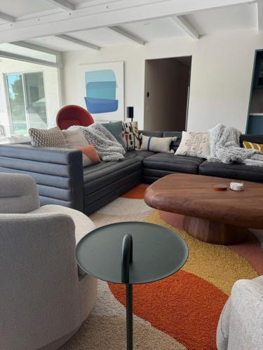 a living room with couches and a coffee table at Aerhaus - Mid-Century Oasis in Palm Springs