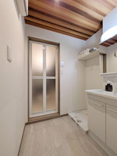 a kitchen with a large window in a room at THE TERRAce HAKATA in Fukuoka