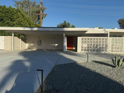a large white building with a red door at Aerhaus - Mid-Century Oasis in Palm Springs