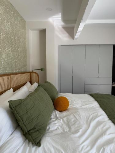 a bedroom with a bed with a pillow on it at Aerhaus - Mid-Century Oasis in Palm Springs