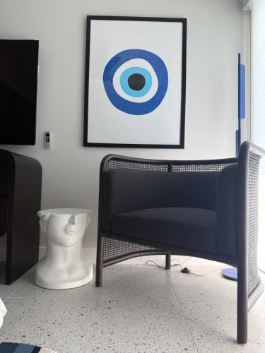 a room with a chair and a picture on the wall at Aerhaus - Mid-Century Oasis in Palm Springs
