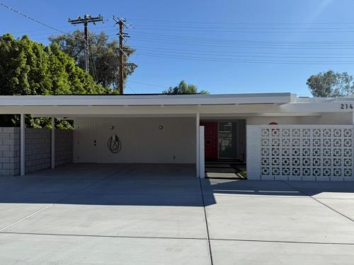 a building with a garage with a sign on it at Aerhaus - Mid-Century Oasis in Palm Springs