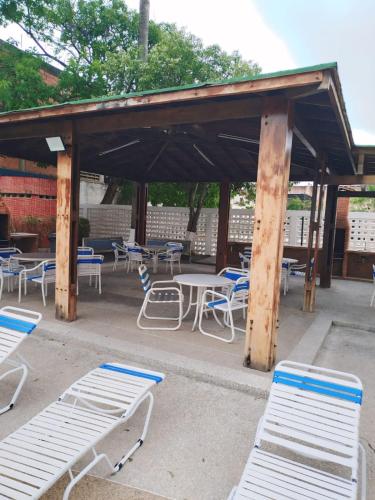 a pavilion with chairs and tables and chairs at Apartamento Punta Brava en el Centro de Tucacas in Tucacas