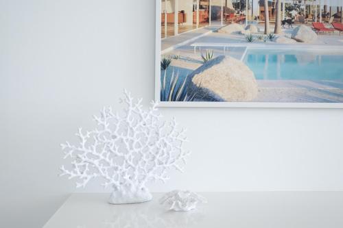 a white vase sitting on a table next to a pool at Premium Beachfront with Unbelievable Views in Sydney