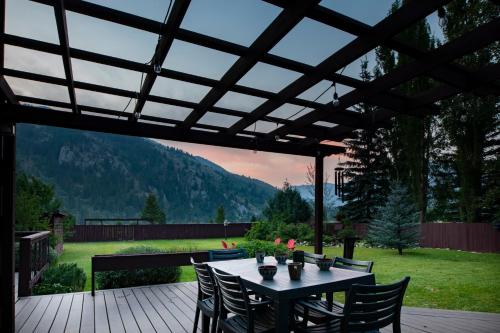 a patio with a table and chairs on a deck at Alpine Highmark in Alpine