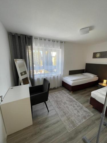 a bedroom with a bed and a desk and a couch at SECRA Exclusive Zum Sternberg in Münsingen