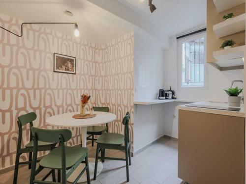 une cuisine avec une table et des chaises dans une pièce dans l'établissement Welcoming Studio for 2 people - Épinettes, à Paris