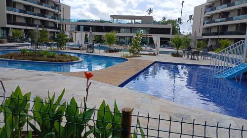 a pool at a hotel with a resort at MALIA MURO ALTO STUDIO 300m DO MAR in Porto De Galinhas