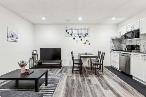 a kitchen and living room with a table and chairs at Basement Suite in Calgary - Short Drive to Banff in Calgary