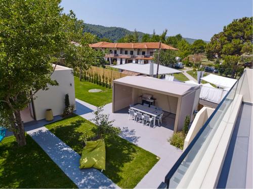 an aerial view of a house with a backyard at Tiamo Secrets - Beach Front in Vourvourou