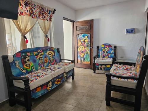 two beds and two chairs in a living room at Hotel Villas Ponto Holbox in Holbox Island