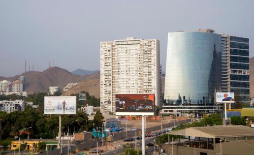 a city with tall buildings and a street with traffic at El Derby 511 Aparts de 3 Dorm con Aire Acondicionado in Lima