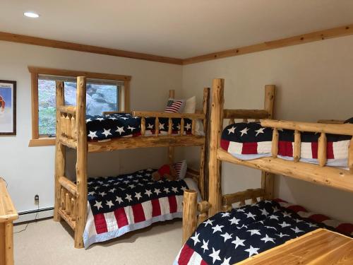 a bedroom with two bunk beds with american flag pillows at Wintertime in Windham